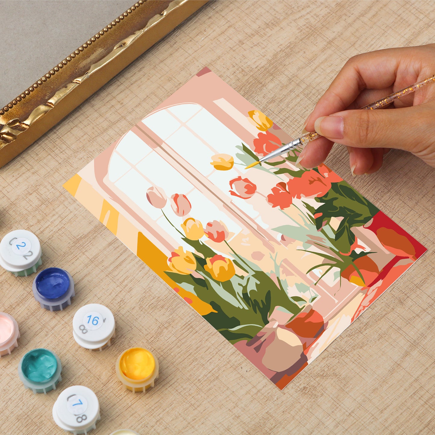 Framed mini paint by numbers of a cozy window filled with blooming flowers and warm decorative details