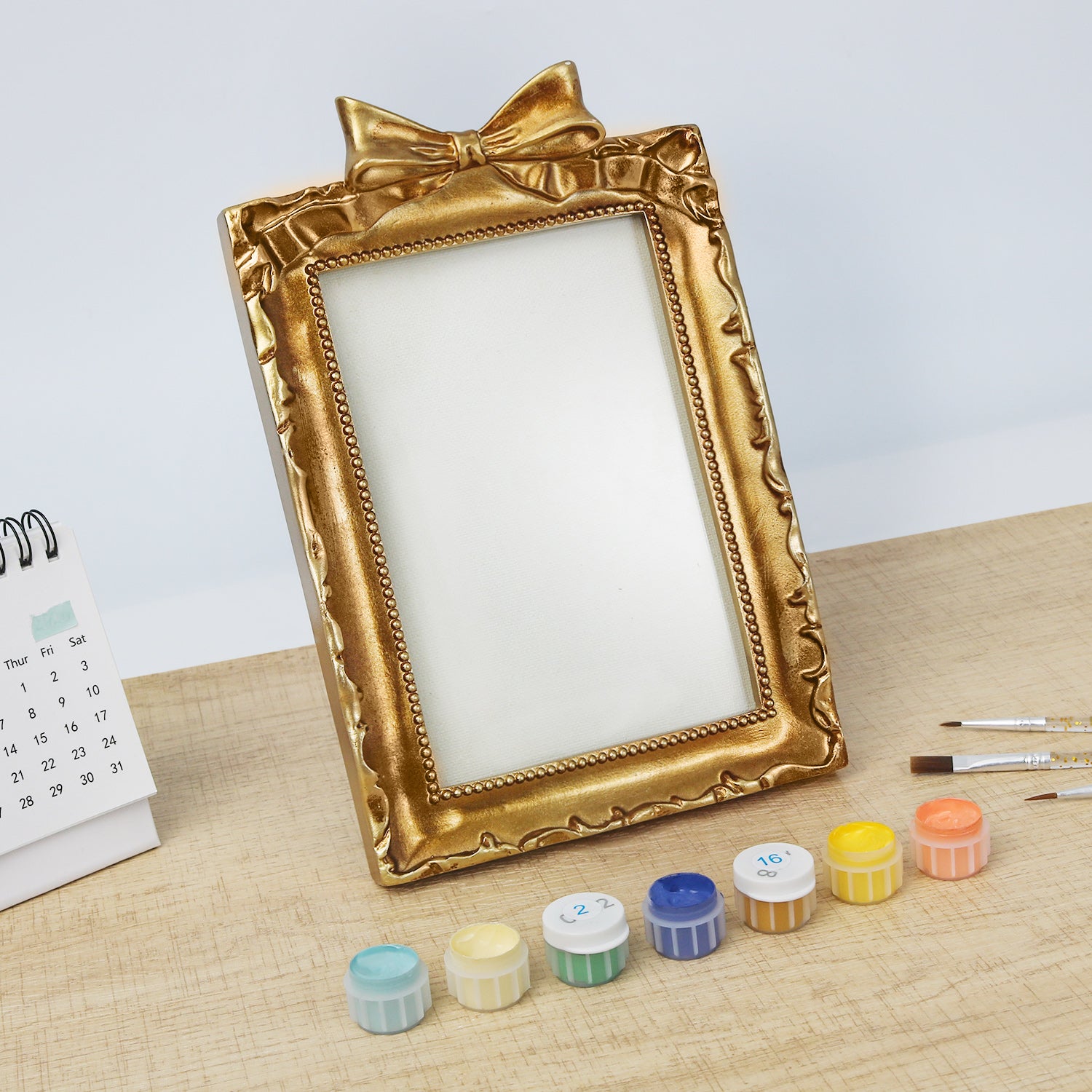 Framed mini paint by numbers of a charming garden door surrounded by lush flowers and greenery