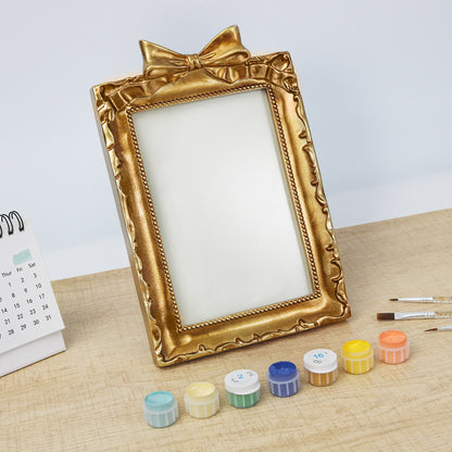 Framed mini paint by numbers of a charming garden door surrounded by lush flowers and greenery