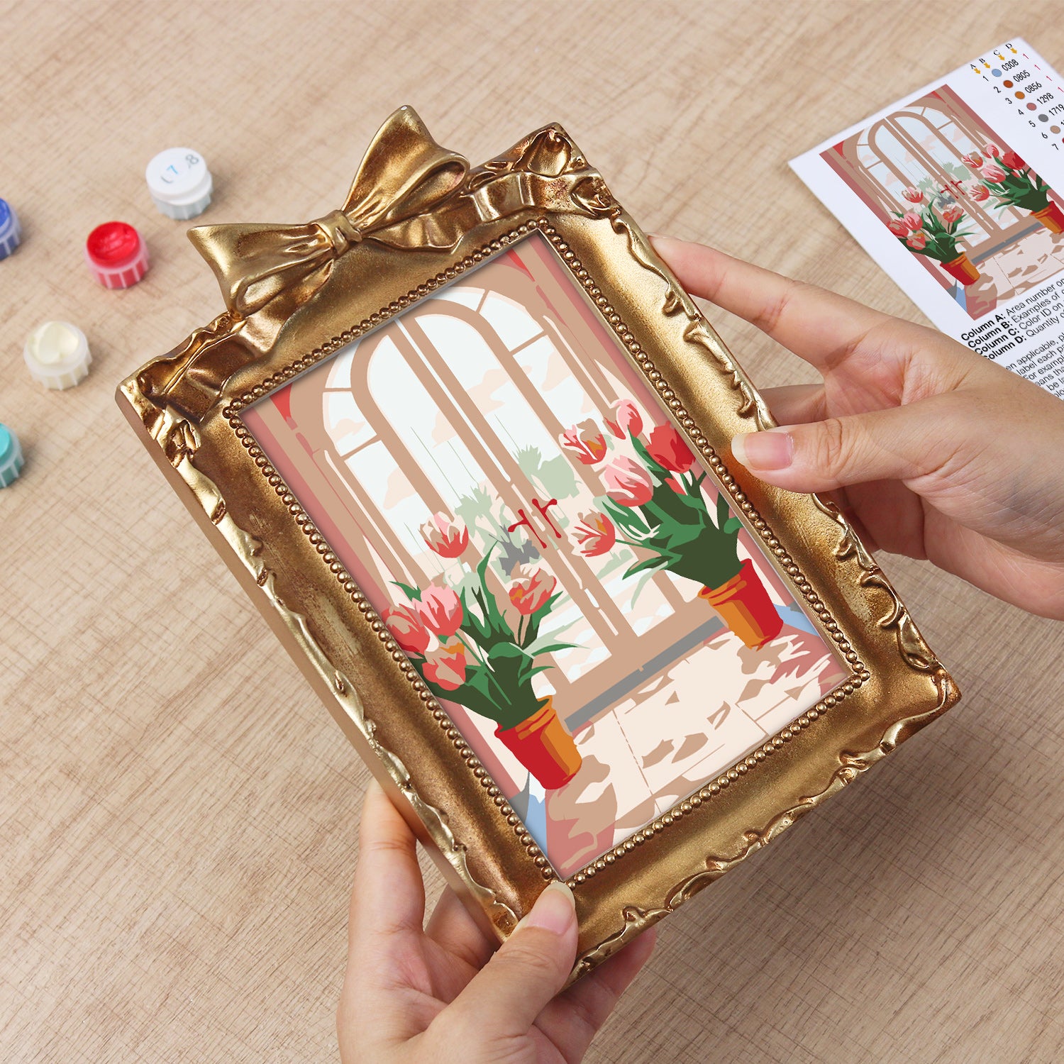 Framed mini paint by numbers featuring a window garden filled with colorful tulips and bright floral accents