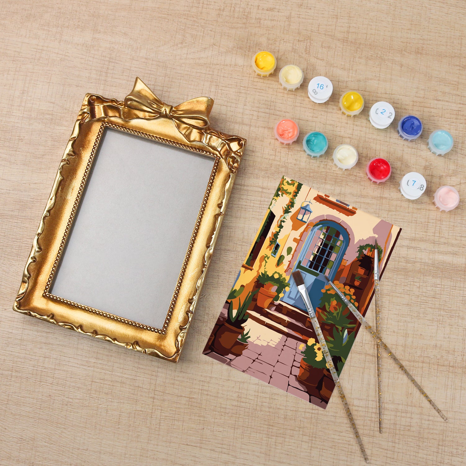 Framed mini paint by numbers of a charming garden door surrounded by lush flowers and greenery