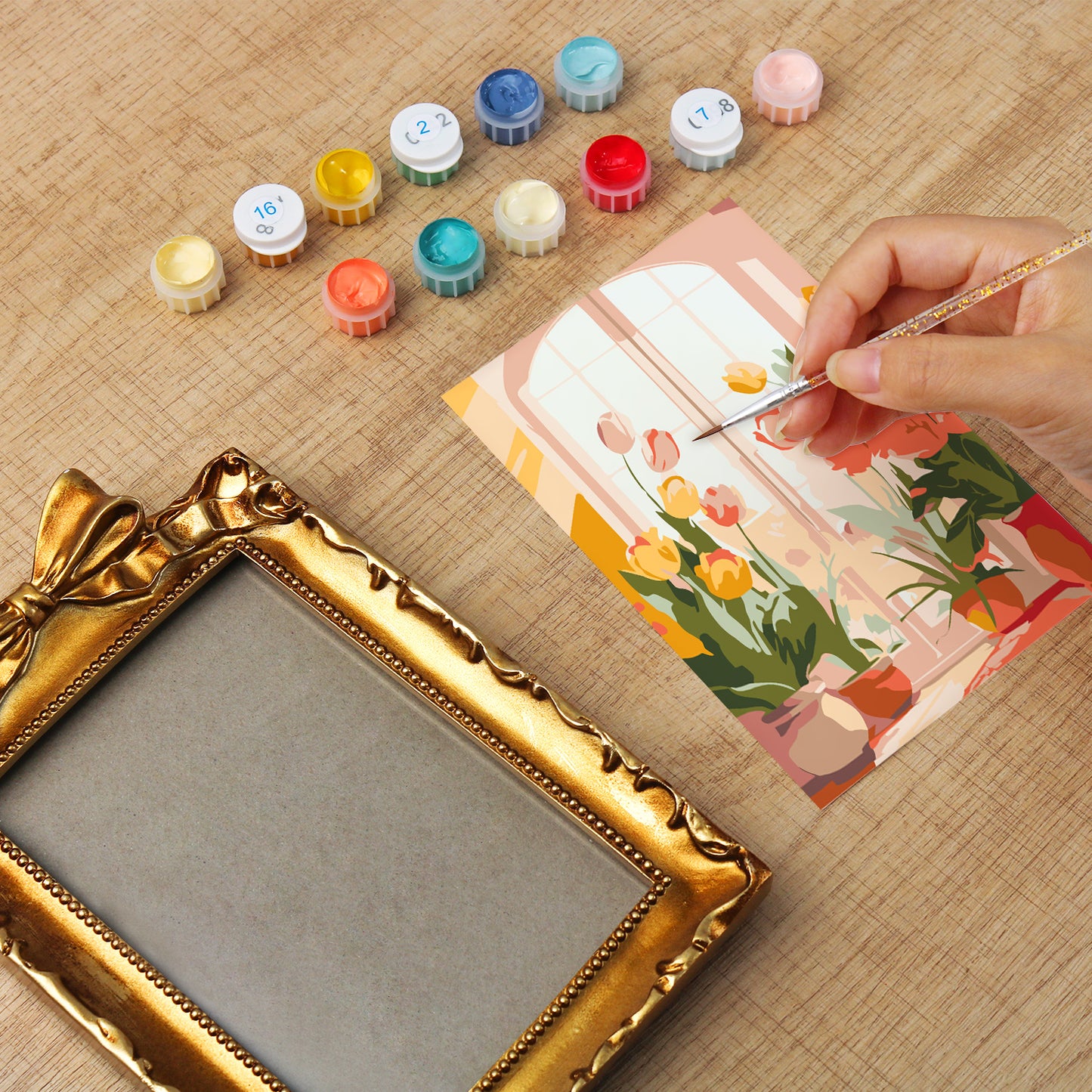 Framed mini paint by numbers of a cozy window filled with blooming flowers and warm decorative details