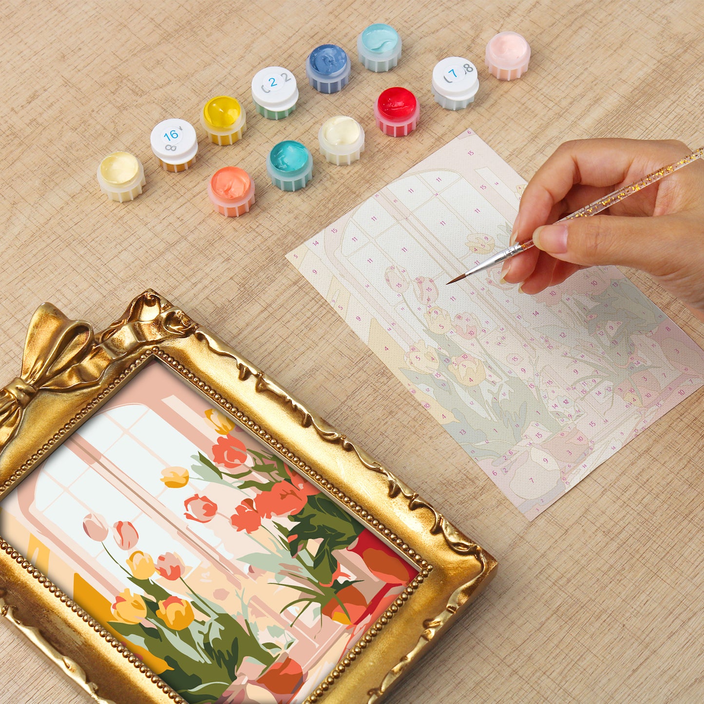 Framed mini paint by numbers of a cozy window filled with blooming flowers and warm decorative details