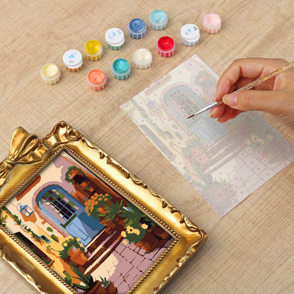 Framed mini paint by numbers of a charming garden door surrounded by lush flowers and greenery