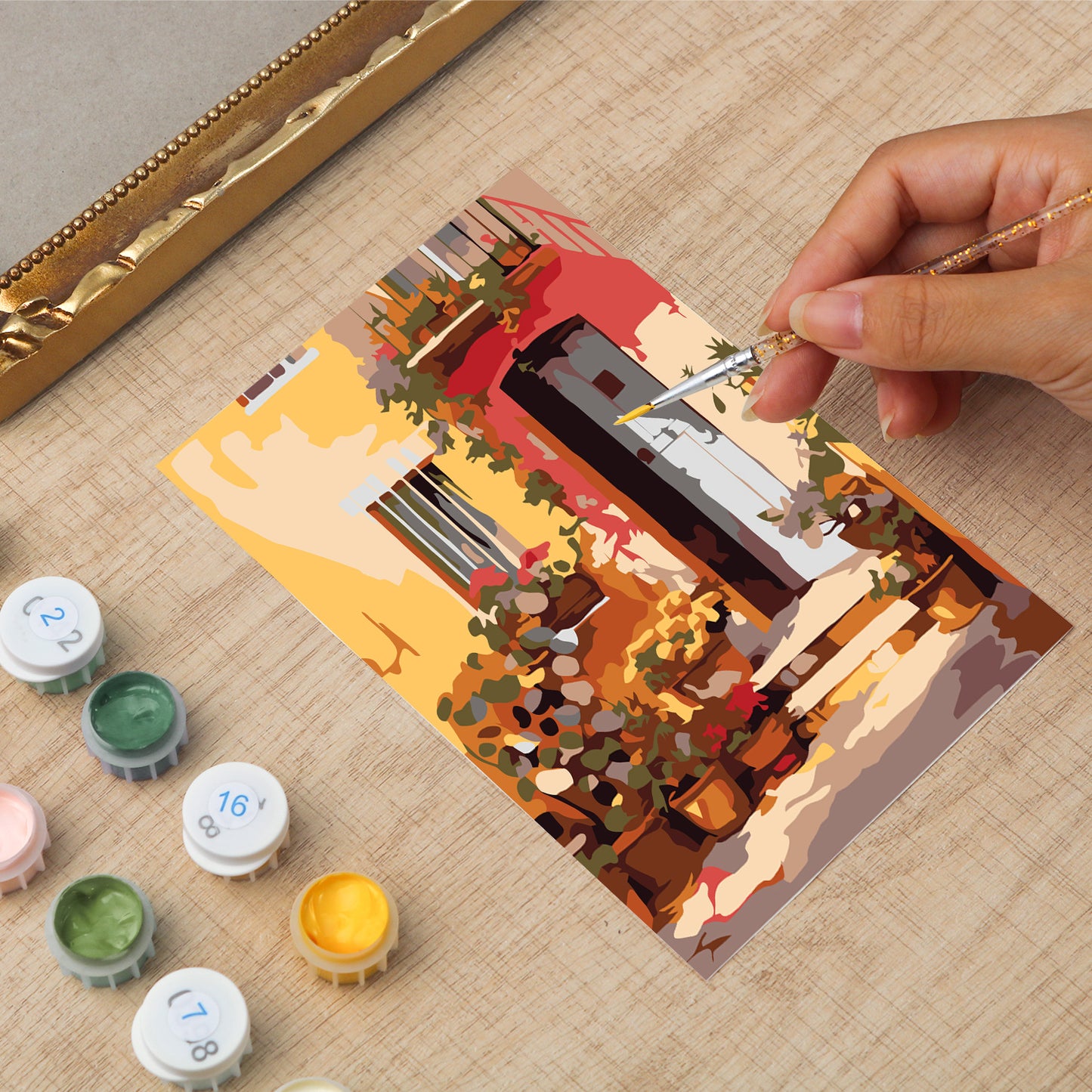 Framed mini paint by numbers showing a Mediterranean passage filled with vibrant flowers and decorative details