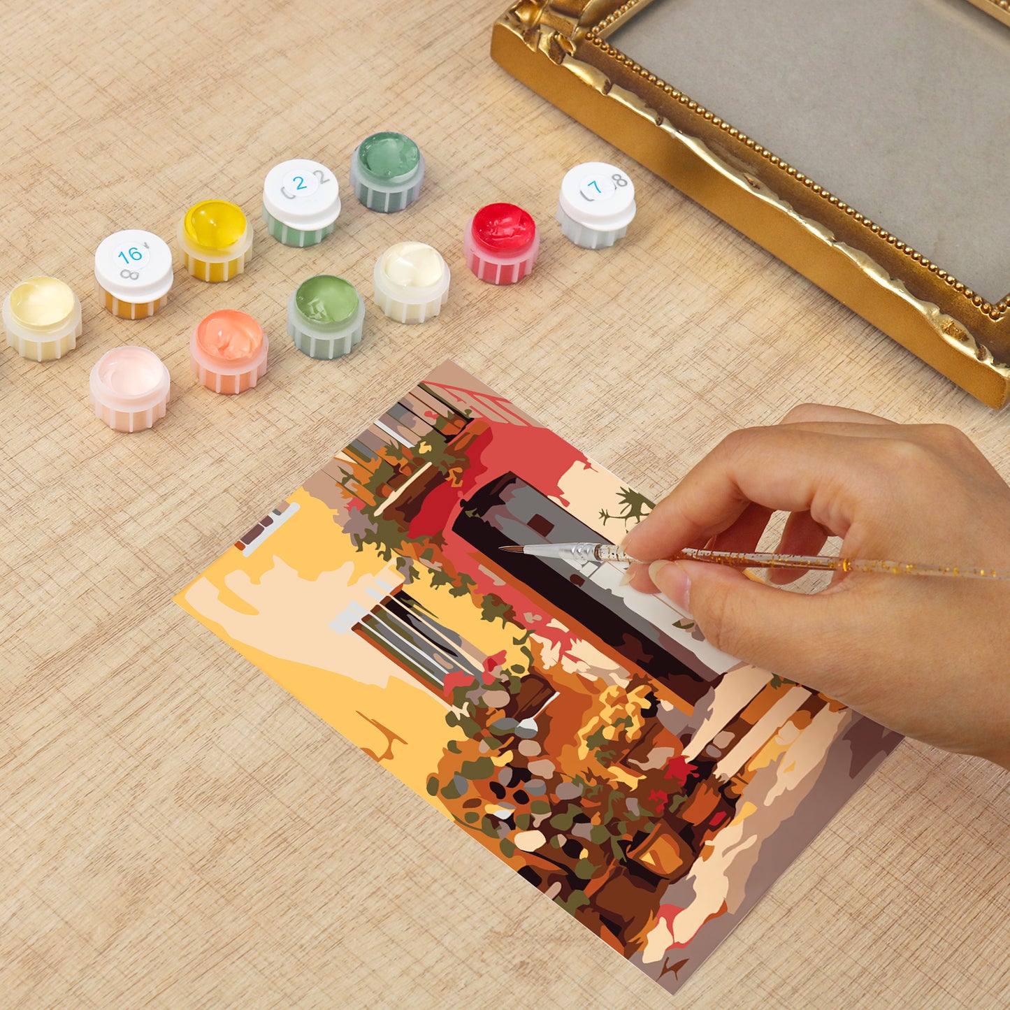 Framed mini paint by numbers showing a Mediterranean passage filled with vibrant flowers and decorative details