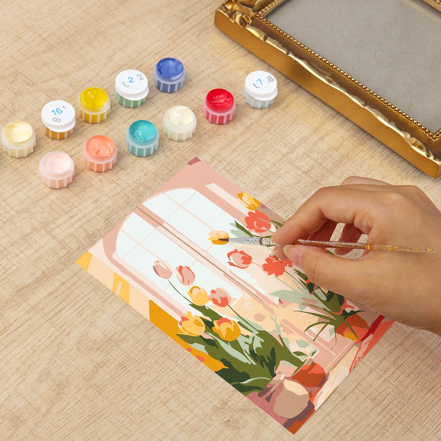 Framed mini paint by numbers of a cozy window filled with blooming flowers and warm decorative details