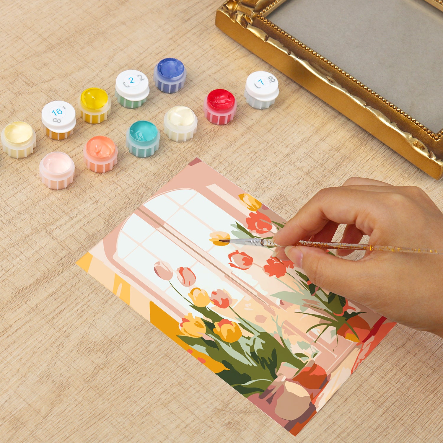 Framed mini paint by numbers of a cozy window filled with blooming flowers and warm decorative details