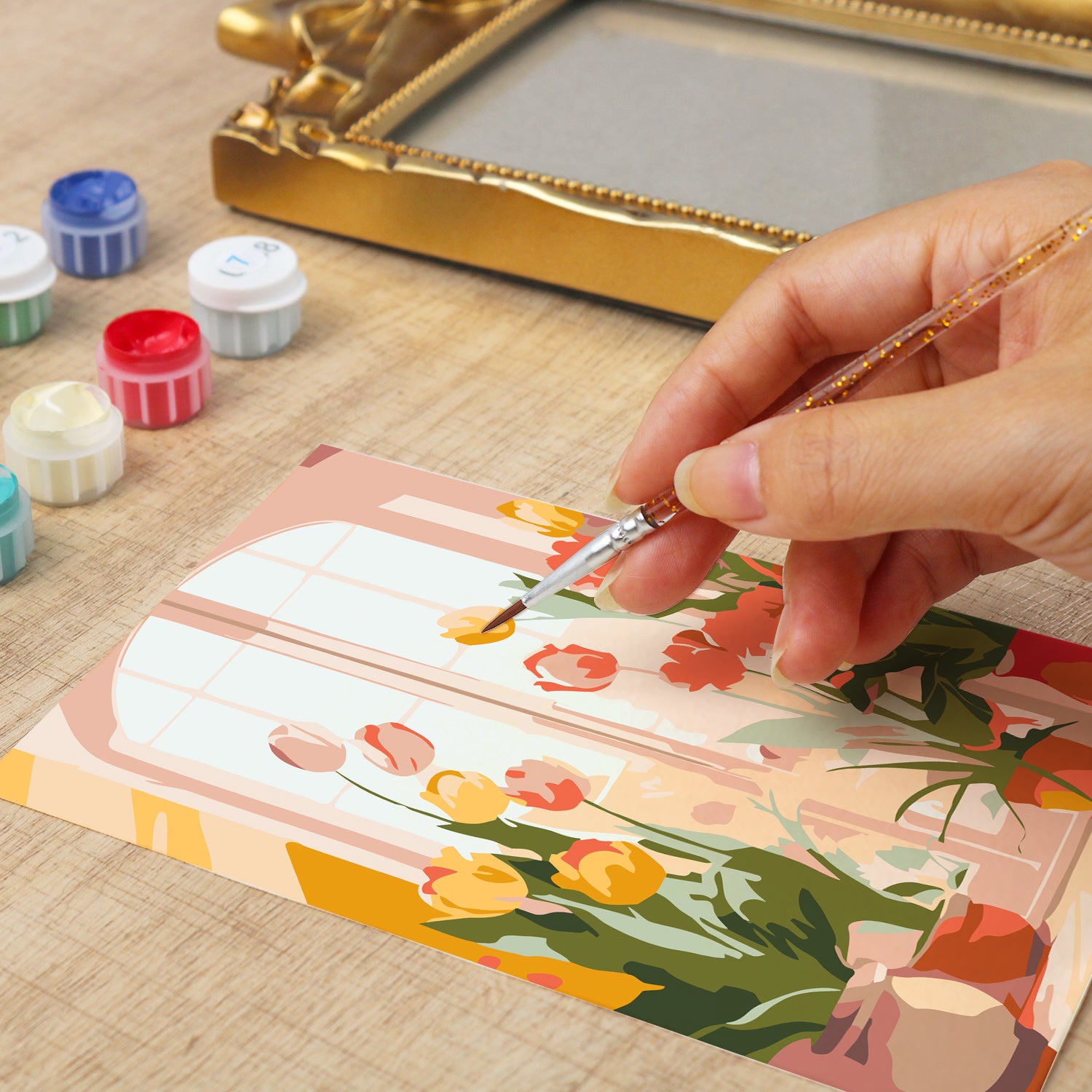 Framed mini paint by numbers of a cozy window filled with blooming flowers and warm decorative details