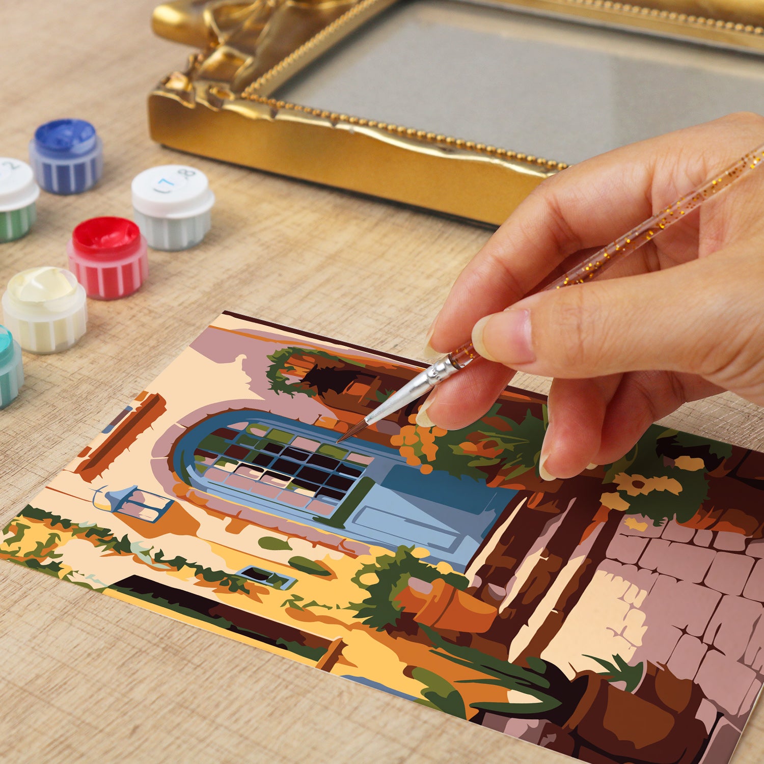 Framed mini paint by numbers of a charming garden door surrounded by lush flowers and greenery