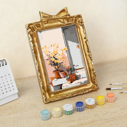 Framed mini paint by numbers of a sunlit indoor plant corner with greenery and natural light