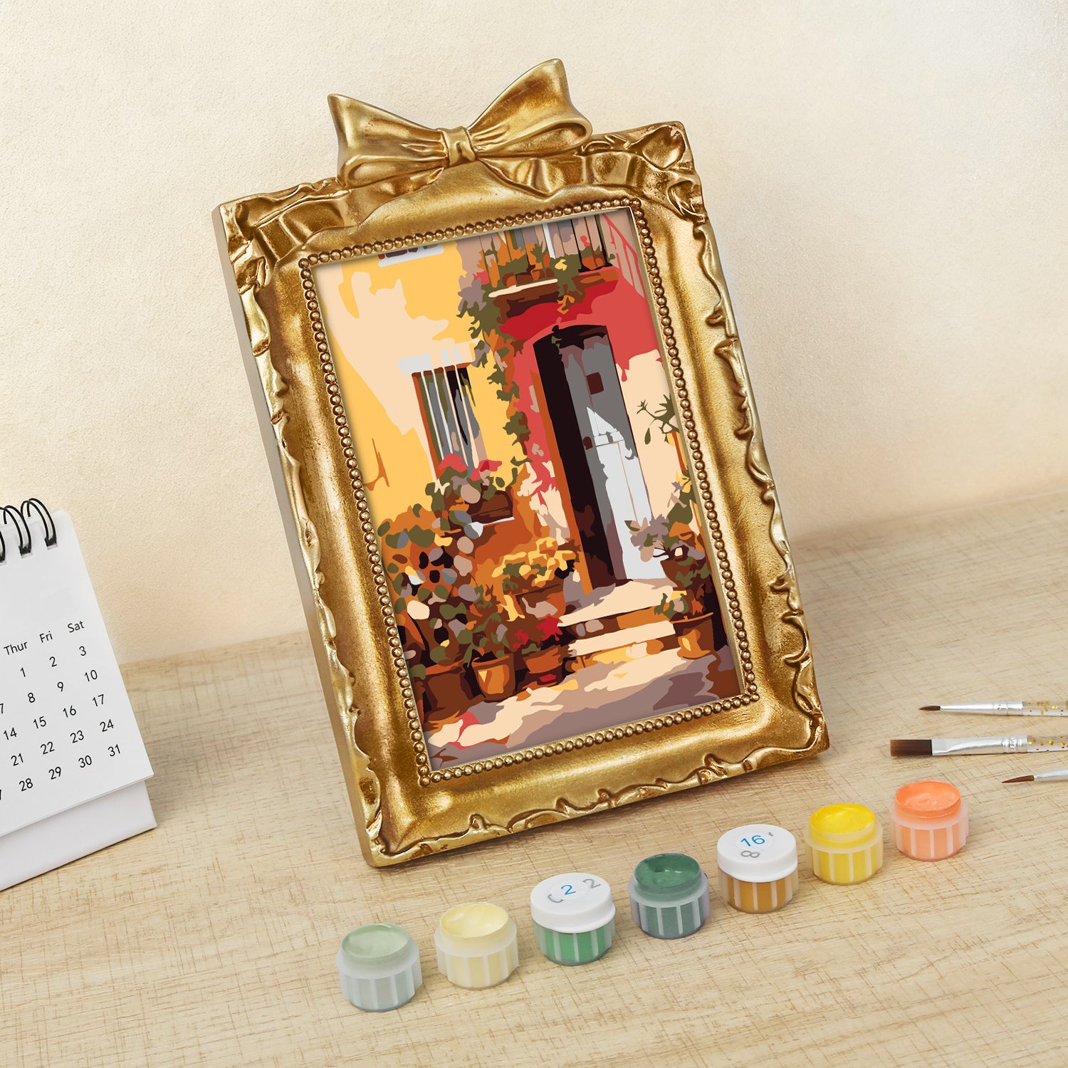 Framed mini paint by numbers showing a Mediterranean passage filled with vibrant flowers and decorative details